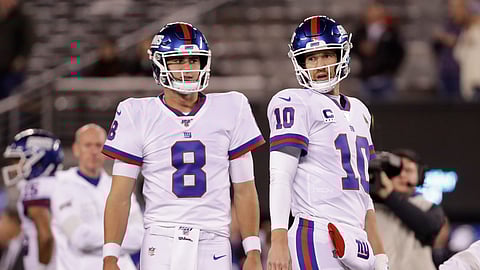 In this Nov. 4, 2019photo, New York Giants quarterback Daniel Jones (8) and quarterback Eli Manning (10) warm up before an NFL football game against the Dallas Cowboys, in East Rutherford, N.J.