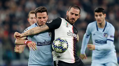 Juventus' Leonardo Bonucci, right, and Atletico Madrid's Saul Niguez challenge for the ball during the Champions League group D soccer match between Juventus and Atletico Madrid at the Allianz stadium in Turin, Italy, Tuesday, Nov. 26, 2019.