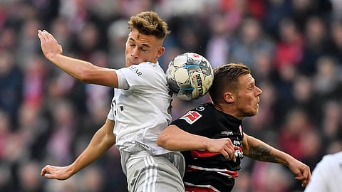 Bayern's Joshua Kimmich, left, and Duesseldorf's Rouwen Hennings challenge for the ball during the German Bundesliga soccer match between Fortuna Duesseldorf and FC Bayern Munich in Duesseldorf, Germany, Saturday, Nov. 23, 2019.