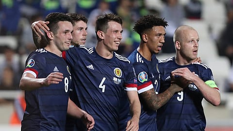 Scotland's John McGinn, left, celebrates with his teammates after scoring his side's second goal during the Euro 2020 group I qualifying soccer match between Cyprus and Scotland at GSP stadium in Nicosia, Saturday, Nov. 16, 2019.