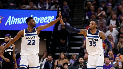 Minnesota Timberwolves' Andrew Wiggins, left, and Robert Covington high-five during a timeout in the closing moments of the their second overtime against the Sacramento Kings in an NBA basketball game in Sacramento, Calif., Thursday, Dec. 26, 2019.