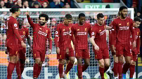 Liverpool's Mohamed Salah, 3rd left, celebrates with teammates after scoring his sides first goal during the English Premier League soccer match between Liverpool and Watford at Anfield stadium in Liverpool, England, Saturday, Dec. 14, 2019.