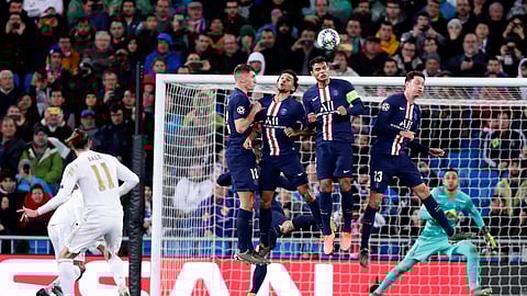 Real Madrid's Gareth Bale, left, takes a free kick during a Champions League soccer match Group A between Real Madrid and Paris Saint Germain at the Santiago Bernabeu stadium in Madrid, Spain, Tuesday, Nov. 26, 2019.