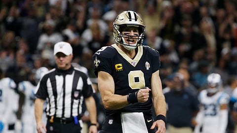 New Orleans Saints quarterback Drew Brees (9) gestures after a touchdown by wide receiver Michael Thomas (13), during the second half at an NFL football game against the Carolina Panthers, Sunday, Nov. 24, 2019, in New Orleans.