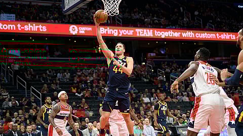 Utah Jazz forward Bojan Bogdanovic (44) goes to the basket against Washington Wizards guard Isaiah Thomas (4) and center Ian Mahinmi (28) during the first half of an NBA basketball game, Sunday, Jan. 12, 2020, in Washington.