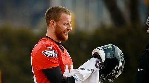 Philadelphia Eagles quarterback Carson Wentz wipes down his helmet at the NFL football team's practice facility in Philadelphia, Thursday, Jan. 2, 2020. The Seattle Seahawks travel to Philadelphia to play the Eagles in an NFC wild-card matchup on Sunday. (AP Photo/Matt Rourke)