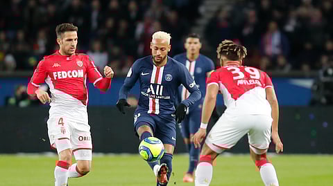 PSG's Neymar, center, is challenged by Monaco's Cesc Fabregas, left, and Benjamin Henrichs during the French League One soccer match between Paris-Saint-Germain and Monaco at the Parc des Princes stadium in Paris, Sunday Jan. 12, 2020.