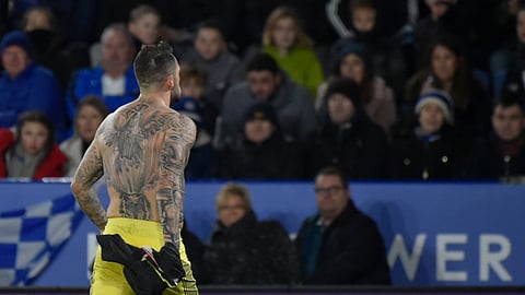 Southampton's Danny Ings takes off his shirt and stands in front of his teams fans as he celebrates after scoring his sides second goal during the English Premier League soccer match between Leicester City and Southampton at the King Power stadium in Leicester, England Saturday, Jan. 11, 2020. (AP Photo/Rui Vieira)