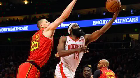 Houston Rockets guard James Harden (13) shoots as Atlanta Hawks center Alex Len defends during the second half of an NBA basketball game Wednesday, Jan. 8, 2020, in Atlanta. Houston won 122-115.