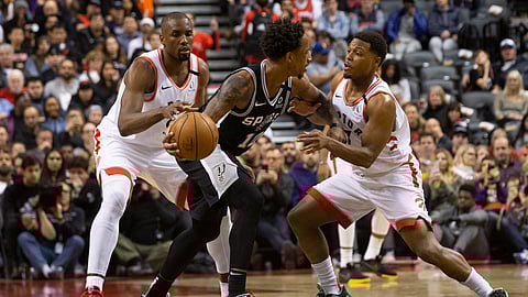 DeMar DeRozan,of the Spurs, works against Kyle Lowry and Serge Ibaka, Jan. 12 in Toronto. The rematch is today in San Antonio. (Chris Young/The Canadian Press via AP)h