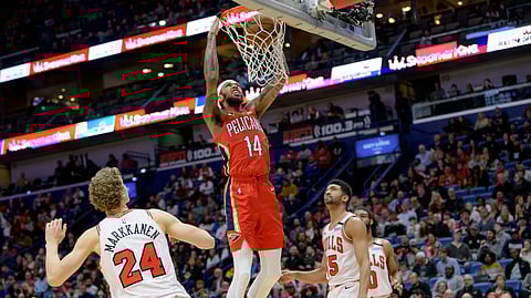 New Orleans Pelicans forward Brandon Ingram (14) goes up for a dunk against Chicago Bulls forward Chandler Hutchison (15) in the second half of an NBA basketball game in New Orleans, Wednesday, Jan. 8, 2020.