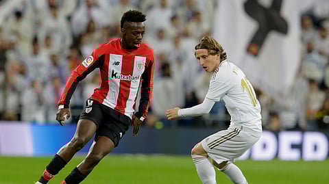 Athletic Bilbao's Inaki Williams, left, and Real Madrid's Luka Modric fight for the ball during a Spanish La Liga soccer match between Real Madrid and Athletic Bilbao at the Santiago Bernabeu stadium in Madrid, Spain, Sunday Dec. 22, 2019.
