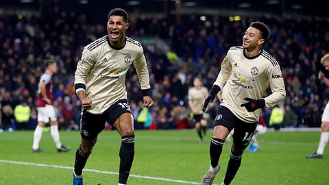 Manchester United's Marcus Rashford, left, celebrates scoring his second goal of the game with team mate Jesse Lingard during the English Premier League soccer match at Turf Moor, Burnley, England, Saturday, Dec. 28, 2019. (Martin Rickett/PA via AP)