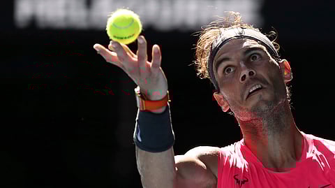 Spain's Rafael Nadal serves to compatriot Pablo Carreno Busta during their third round singles match at the Australian Open tennis championship in Melbourne, Australia, Saturday, Jan. 25, 2020. (AP Photo/Dita Alangkara)