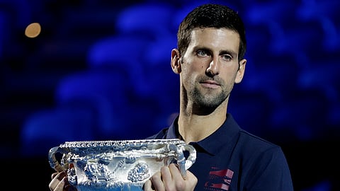 Defending men's singles champion Serbia's Novak Djokovic holds the Norman Brookes Challenge Cup during the official draw ceremony on Margaret Court Arena ahead of the Australian Open tennis championship in Melbourne, Australia, Thursday, Jan. 16, 2020. (AP Photo/Mark Baker)