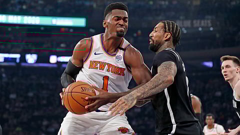 Brooklyn Nets forward Wilson Chandler (21) defends New York Knicks forward Bobby Portis (1) as Portis rives to the basket during the first half of an NBA basketball game in New York, Sunday, Jan. 26, 2020.