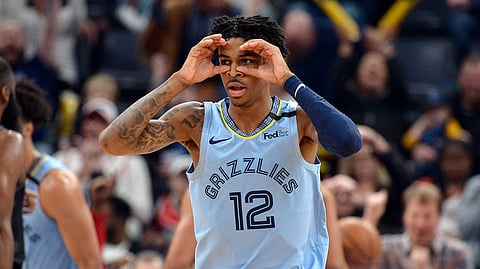 Memphis Grizzlies guard Ja Morant reacts after an assist in the first half of the team's NBA basketball game against the Houston Rockets on Tuesday, Jan. 14, 2020, in Memphis, Tenn. (AP Photo/Brandon Dill)