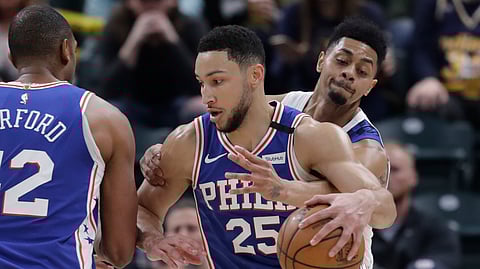 Philadelphia 76ers' Ben Simmons (25) is defended by Indiana Pacers' Jeremy Lamb (26) during the first half of an NBA basketball game, Monday, Jan. 13, 2020, in Indianapolis.
