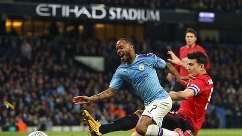 Manchester United's Harry Maguire tackles Manchester City's Raheem Sterling, left, during the English League Cup semifinal second leg soccer match between Manchester City and Manchester United at Etihad stadium in Manchester, England, Wednesday, Jan. 29, 2020.