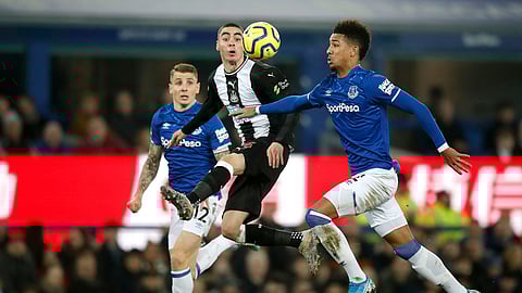 Newcastle United's Miguel Almiron, centre, battles with Everton's Lucas Digne, left, and Mason Holgate during their English Premier League soccer match at Goodison Park in Liverpool, England, Tuesday Jan. 21, 2020.
