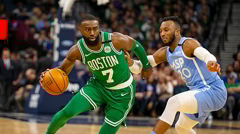 Boston Celtics guard Jaylen Brown (7) drives against Minnesota Timberwolves guard Josh Okogie (20) in the second quarter of an NBA basketball game Friday, Feb. 21, 2020, in Minneapolis. (AP Photo/Andy Clayton-King)