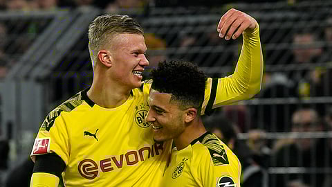 Dortmund's scorer Erling Haaland celebrates with Jadon Sancho, right, after he scored his side's 5th goal during the German Bundesliga soccer match between Borussia Dortmund and 1. FC Cologne in Dortmund, Germany, Friday, Jan. 24, 2020. Dortmund defeated Cologne with 5-1, Haaland scored twice.