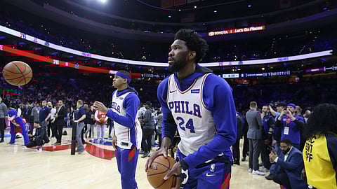 Philadelphia 76ers' Joel Embiid, front, and teammates wear jerseys with Kobe Bryant's number on them before the team's NBA basketball game against the Golden State Warriors on Tuesday, Jan. 28, 2020, in Philadelphia.