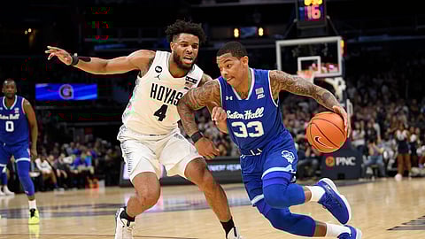 Seton Hall guard Shavar Reynolds (33) dribbles the ball next to Georgetown guard Jagan Mosely (4) during the first half of an NCAA college basketball game, Wednesday, Feb. 5, 2020, in Washington. (AP Photo/Nick Wass)