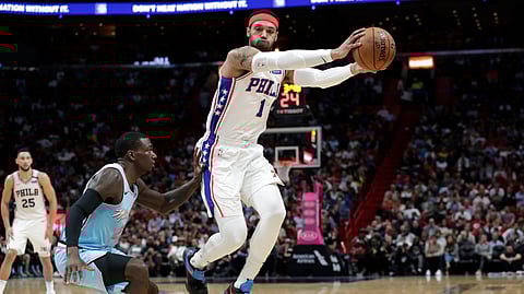 Philadelphia 76ers forward Mike Scott (1) gets a loose ball as Miami Heat guard Kendrick Nunn, left, defends during the first half of an NBA basketball game, Monday, Feb. 3, 2020, in Miami.