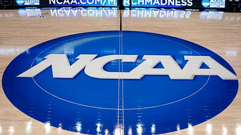 In this March 18, 2015, file photo, the NCAA logo is displayed at center court as work continues at The Consol Energy Center in Pittsburgh, for the NCAA college basketball tournament.