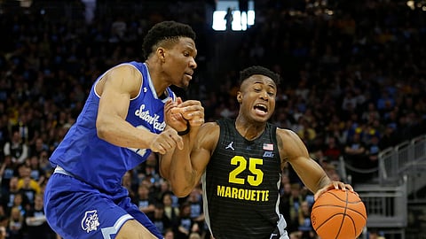 Marquette's Koby McEwen (25) drives to the basket against Seton Hall's Ike Obiagu during the first half of an NCAA college basketball game Saturday, Feb. 29, 2020, in Milwaukee. (AP Photo/Aaron Gash)