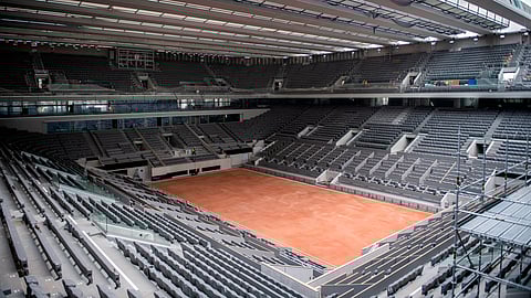 In this Feb. 5, 2020, file photo, construction work of the newly built roof of the Philippe Chatrier center court is pictured at Roland Garros stadium in Paris. The French Open has been postponed because of the coronavirus. The French Tennis Federation announced Tuesday, March 17, 2020, that the clay-court event will run from Sept. 20 to Oct. 4. Main draw competition was supposed to start on May 24.
