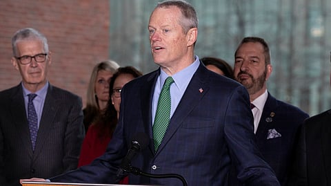 Massachusetts Gov. Charlie Baker speaks during a news conference outside Boston City Hall in front of Mayor Marty Walsh (right) and CEO of the Boston Athletic Association Thomas Grilk (left) on March 13 (Michael Dwyer)