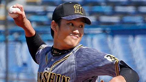 In this March 11, 2020, photo, Hanshin Tigers pitcher Shintaro Fujinami throws a ball against Yakult Swallows in a pre-season match in Tokyo. Fujinami became the first professional baseball player in Japan to test positive for the new coronavirus. Fujinami was examined at a hospital and a doctor recommended he have a PCR test for the new coronavirus. Kyodo News agency reported on Friday, March 27, that the result was positive.
