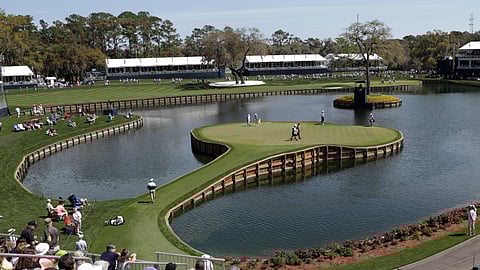 Cameron Champ, Nate Lashley, Kevin Tway and their caddies, walk the 17th green, during the first round of The Players Championship golf tournament Thursday, March 12, 2020 in Ponte Vedra Beach, Fla.