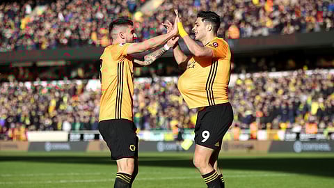 Wolverhampton Wanderers' Raul Jimenez, right, celebrates scoring against Norwich City during the English Premier League soccer match at Molineux, Wolverhampton, England, Sunday Feb. 23, 2020.