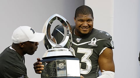 AFC defensive end Calais Campbell, of the Jacksonville Jaguars, (93) holds the Pro Bowl trophy after the NFL Pro Bowl football game, Sunday, Jan. 26, 2020, in Orlando, Fla. The AFC defeated the NFC 38-33. Campbell won the MVP defensive player of the game.