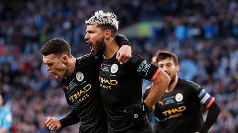 Manchester City's Sergio Aguero, right, celebrates with his teammate Phil Foden after scoring his side's first goal during the League Cup soccer match final between Aston Villa and Manchester City, at Wembley stadium, in London, England, Sunday, March 1, 2020.