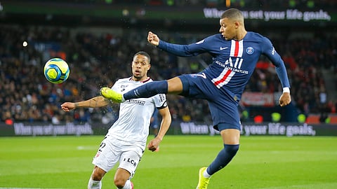 Dijon's Mickael Alphonse, left, and PSG's Kylian Mbappe challenge for the ball during the French League One soccer match between Paris-Saint-Germain and Dijon, at the Parc des Princes stadium in Paris, France, Saturday, Feb. 29, 2020.