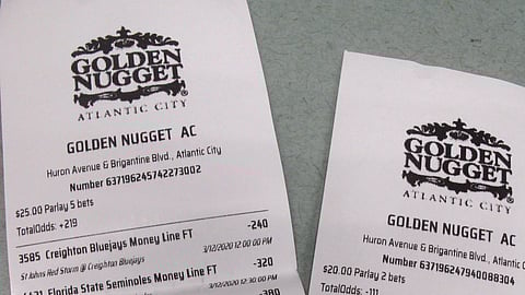 This March 12, 2020 shows a sports betting ticket at the Golden Nugget casino in Atlantic City, N.J. where all five games that were bet on were canceled due to coronavirus precautions. Most professional and college sports events in the U.S. have been suspended or delayed, leaving little to bet on. For most people, the new coronavirus causes only mild or moderate symptoms. For some it can cause more severe illness. (AP Photo/Wayne Parry)