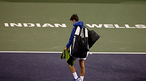 In this Monday, March 11, 2019, file photo, Novak Djokovic, of Serbia, walks off the court during a rain break in his match against Philipp Kohlschreiber, of Germany, at the BNP Paribas Open tennis tournament in Indian Wells, Calif. The BNP Paribas Open tennis tournament, set to begin Wednesday, March 11, 2020, has been postponed after a case of coronavirus was confirmed in the Coachella Valley.
