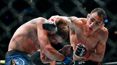 In this June 8, 2019, file photo, Tony Ferguson, right, punches Donald Cerrone, left, during their lightweight mixed martial arts bout at UFC 238 in Chicago. The UFC says Ferguson will fight Justin Gaethje for the interim lightweight title in the main event of UFC 249 on April 18, 2020. The mixed martial arts promotion announced the matchup Monday, April 6, 2020. Gaethje replaces lightweight champ Khabib Nurmagomedov, who is apparently unable to leave Russia during the coronavirus pandemic.