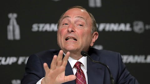 In this May 27, 2019, file photo, NHL Commissioner Gary Bettman speaks to the media before Game 1 of the NHL hockey Stanley Cup Final between the St. Louis Blues and the Boston Bruins in Boston. The most aggressive timetable, a person familiar with discussions told The Associated Press, would have players returning to their home rinks as early as May 15, followed by a training camp and possible exhibition games in June.