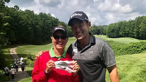 Andrew Yun, shown here with a fan who saved his glove, is one of the favorites at the Arrowhead Classic