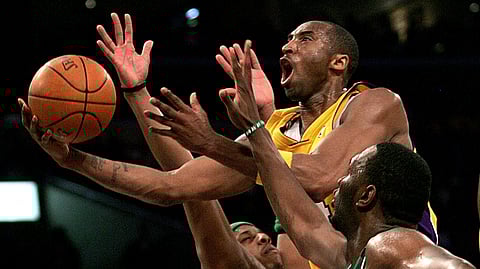 In this Feb. 23, 2007, file photo, Los Angeles Lakers' Kobe Bryant, top, goes up for a shot between Boston Celtics' Paul Pierce, left, and Al Jefferson during the first half of an NBA basketball game in Los Angeles. Kobe Bryant, Tim Duncan and Kevin Garnett are all expected to be officially announced as members of the 2020 enshrinement class for the Basketball Hall of Fame on Saturday, April 4, 2020.