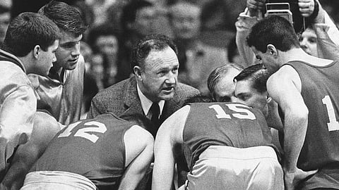In this Dec, 6, 1985, file photo, actor Gene Hackman gives fictional Hickory High basketball players instructions during filming of the final game of the movie "Hoosiers" at Hinkle Fieldhouse on the Butler University campus in Indianapolis. “Hoosiers” shot all the way to No. 1 in The Associated Press Top 25 of best sports movies, a one-of-a-kind poll from the news organization known for its rankings of college teams.