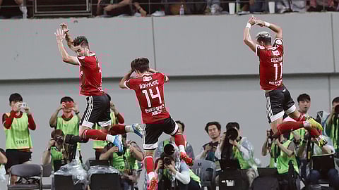 In this July 26, 2019, file photo, Cesinha, right, of Team K League jumps with his teammates to celebrate after scoring a goal against Juventus during a friendly match at the Seoul World Cup Stadium in Seoul, South Korea. Players, coaches and fans have two weeks to get used to new rules around soccer in South Korea after the K-League announced that the delayed season will kick off on May 8.
