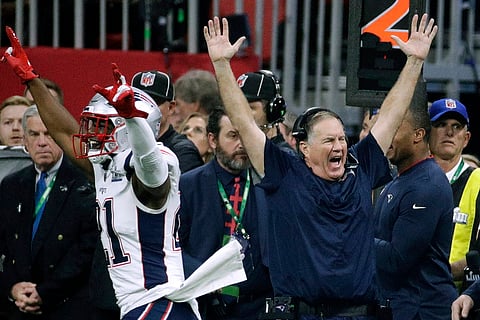 New England's Duron Harmon (21) and head coach Bill Belichick celebrate the Patriots' Super Bowl 53 victory