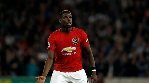 In this Monday, Aug. 19, 2019 file photo, Manchester United's Paul Pogba reacts during their English Premier League soccer match against Wolverhampton Wanderers at the Molineux Stadium in Wolverhampton, England. Paul Pogba and Marcus Rashford are expected to be available for Manchester United whenever the Premier League is allowed to resume after its suspension because of the coronavirus outbreak. They were both sidelined with long-term injuries at the time play was halted in England.