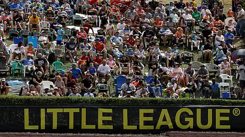 Little League World Series fans watch from the hillside overlooking left field at Lamade Stadium during the 2019 International Championship Game between Curacao and Japan